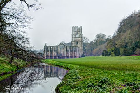 Fountains Abbey, England with green grass and water