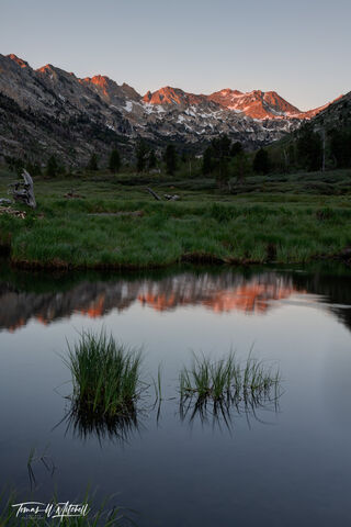sunrise over beaver pond and mountains