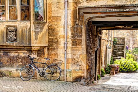 Bike leaning against old building in the Cotswolds, England.