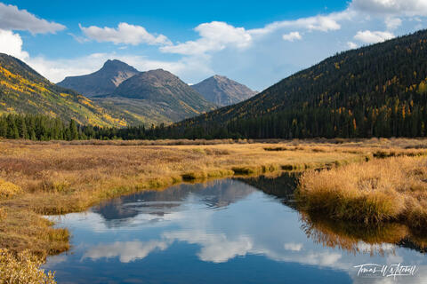 autumn scene in the Uinta Mountains with water, blue sky and clouds
