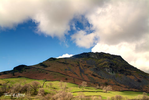 English hillside with stone walls and cloudy sky