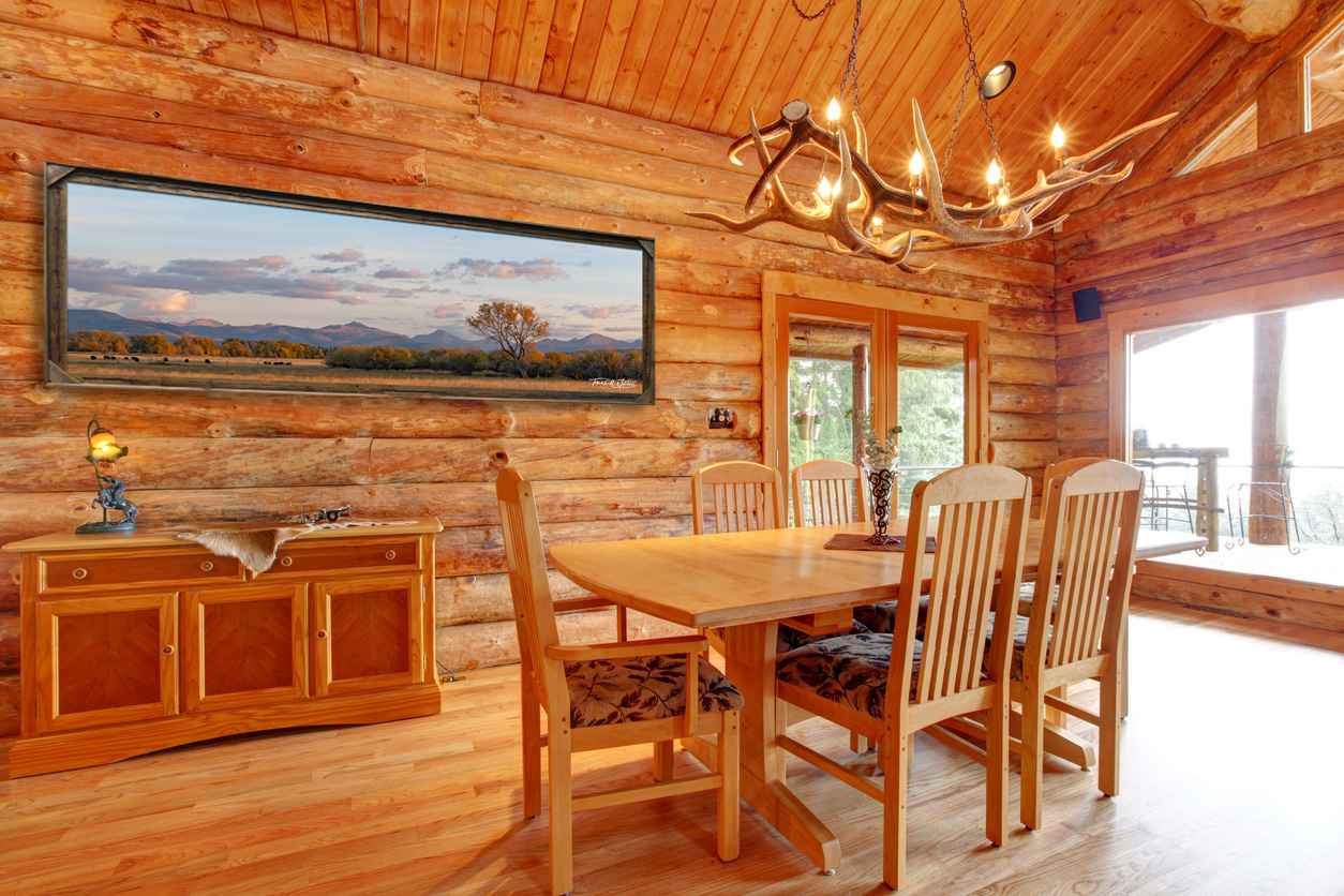 framed photograph of mountain vista in the fall on wall of a cabin.
