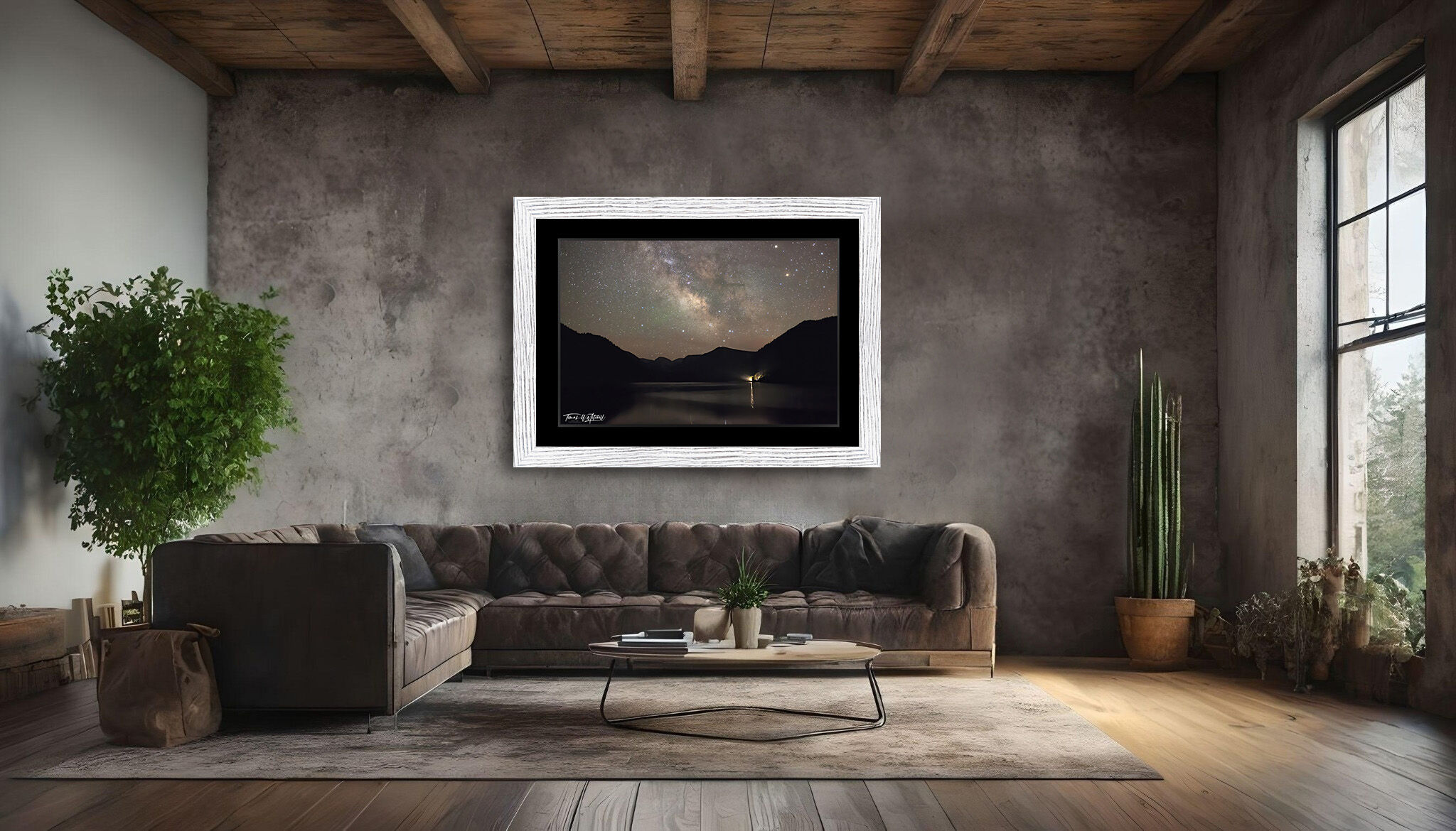 framed photograph of Milky Way Night sky over lake on home wall.