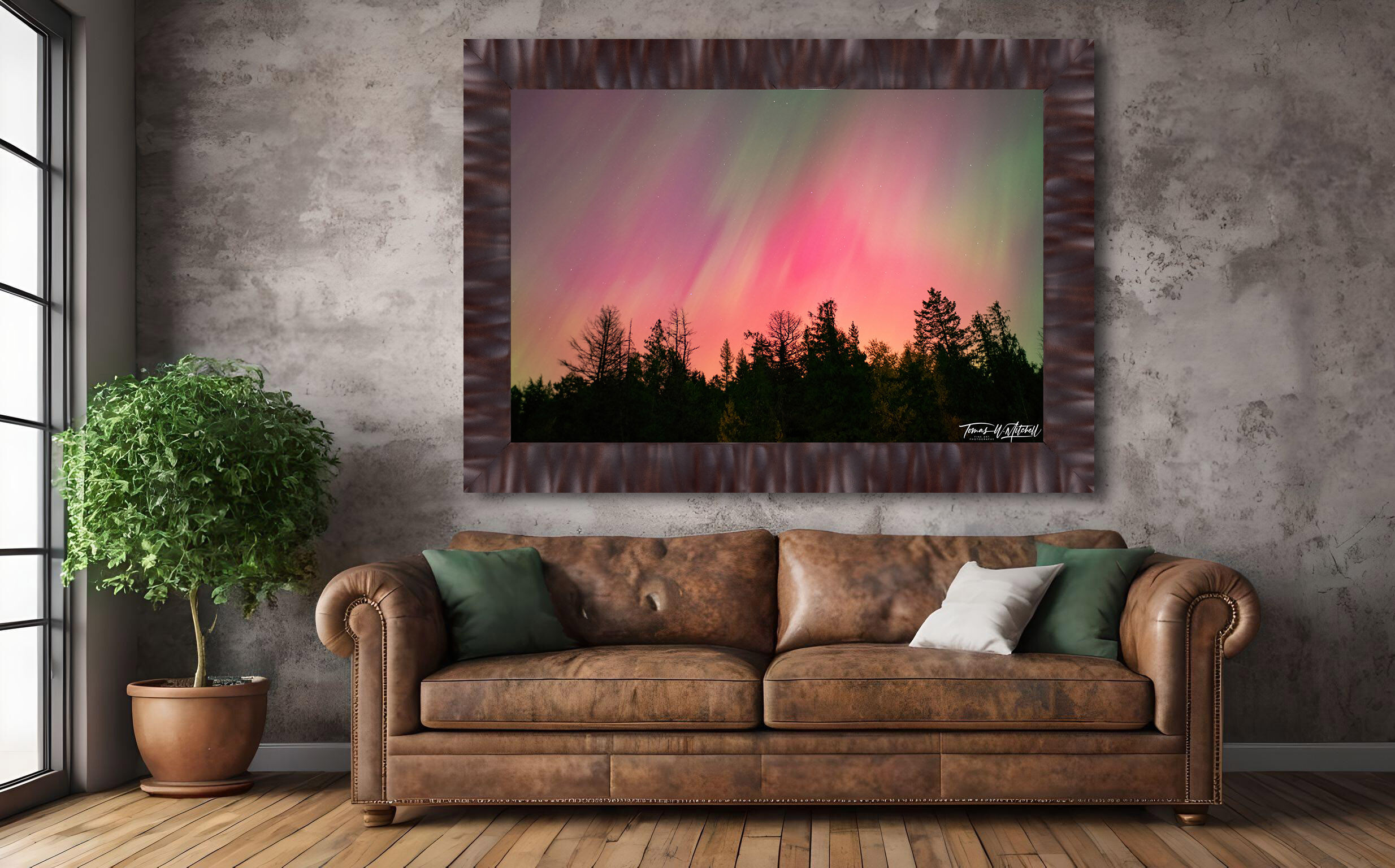 framed photograph of northern lights on home wall