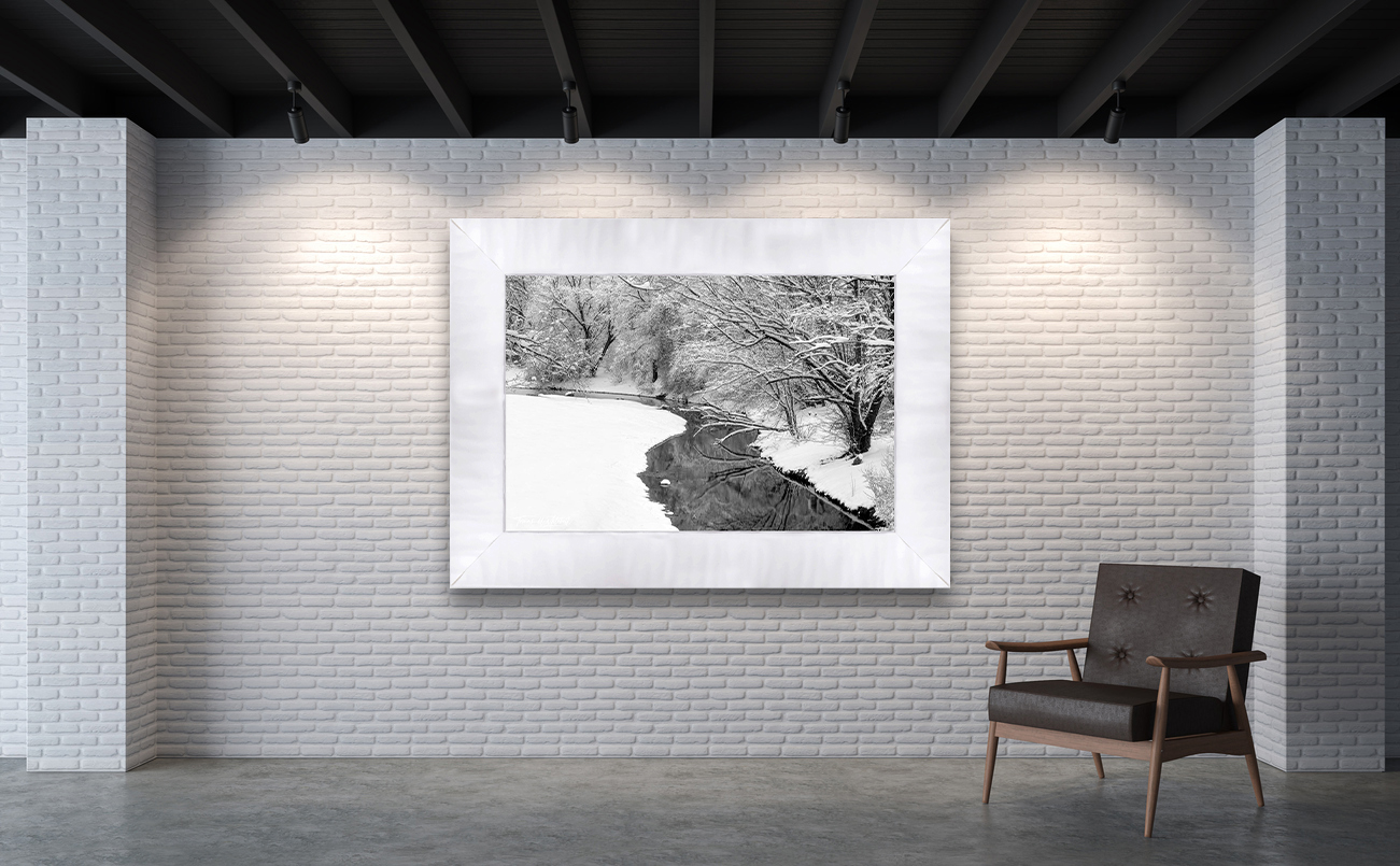 framed photograph of river in winter on gallery wall