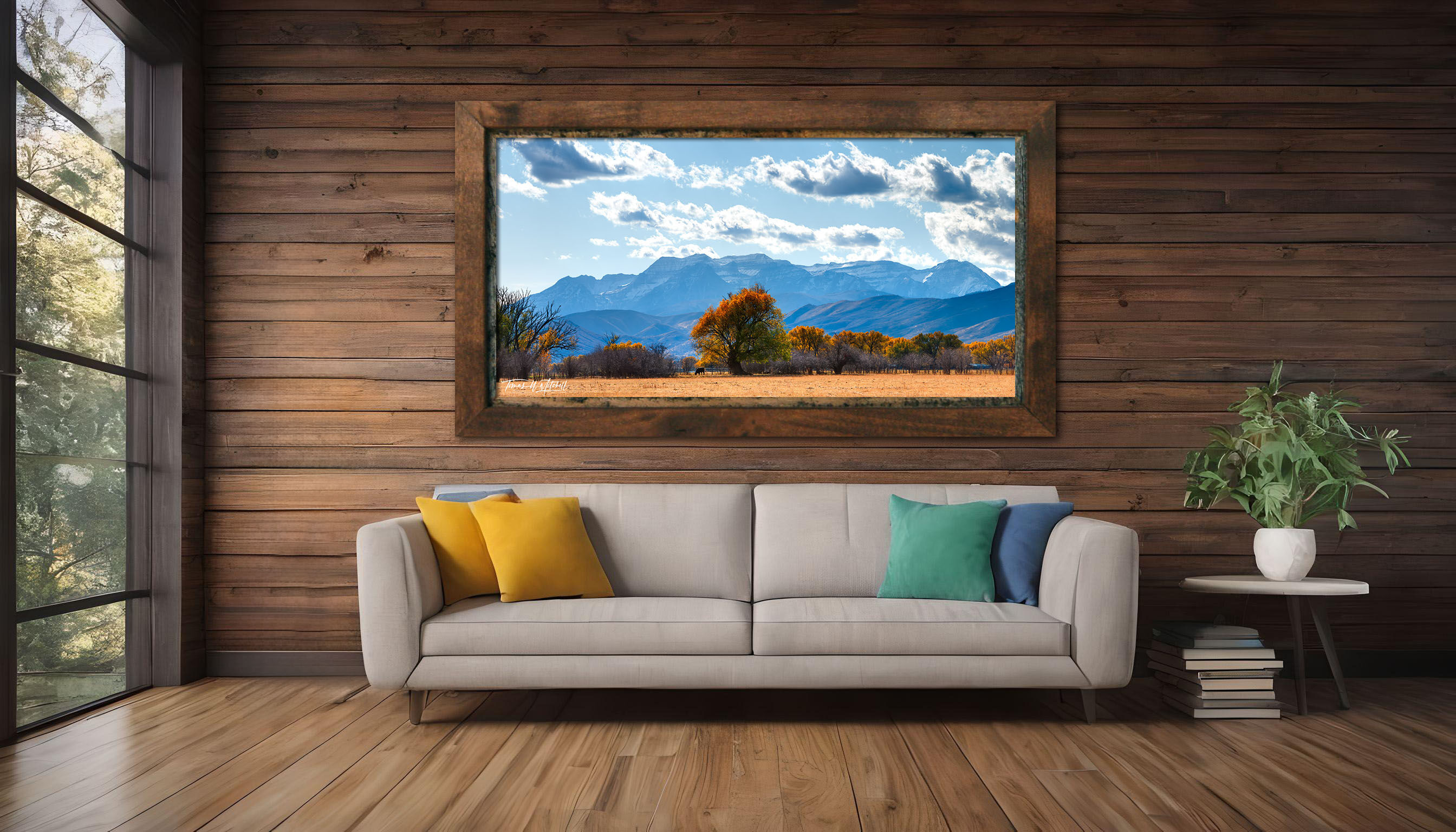 framed photograph of autumn trees and mountain on home wall