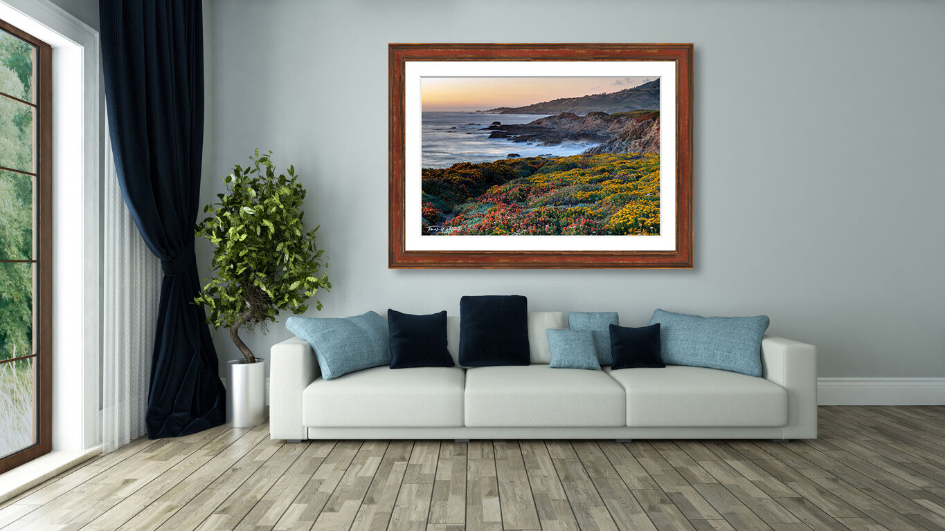 framed photograph of sunset and wildflowers on home wall