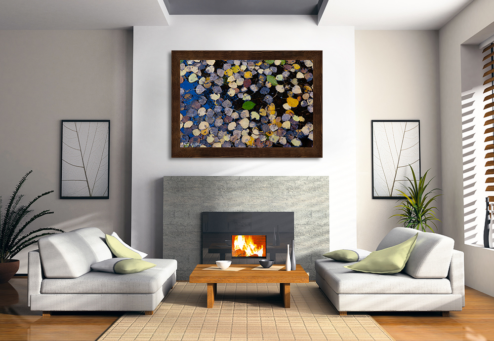 framed photograph of autumn leaves in water on home wall.
