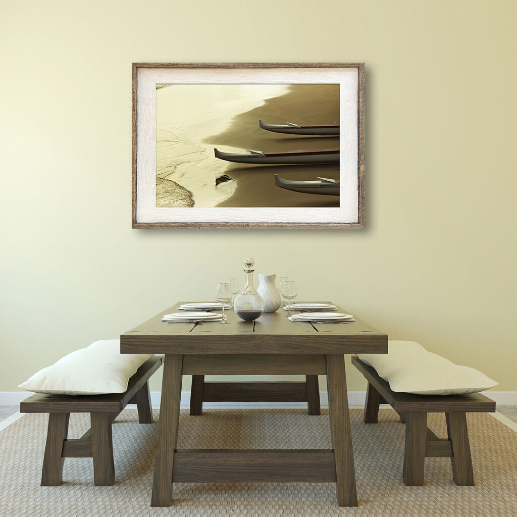 framed photograph of boats on beach on home wall