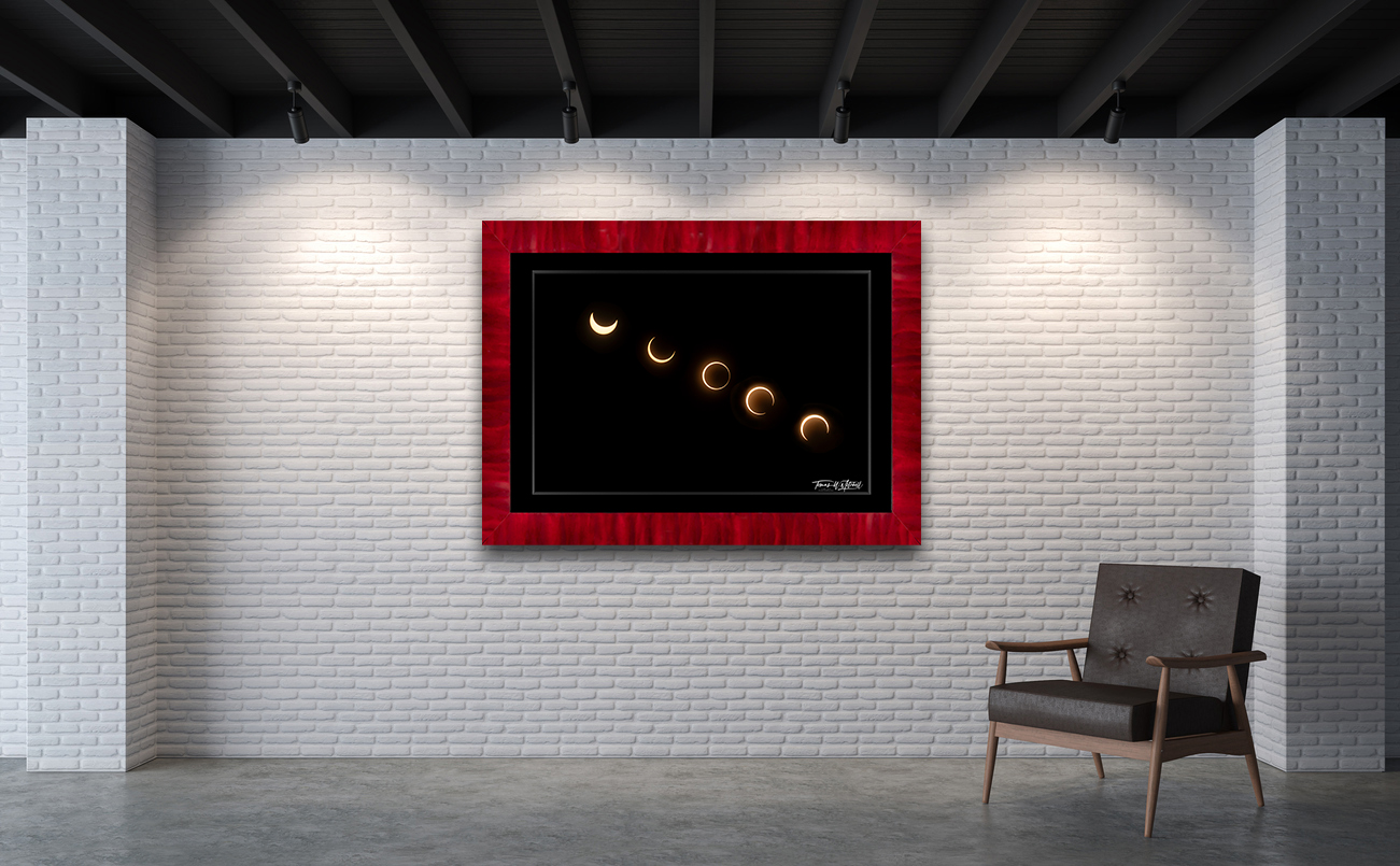 framed photograph of annular eclipse on gallery wall.